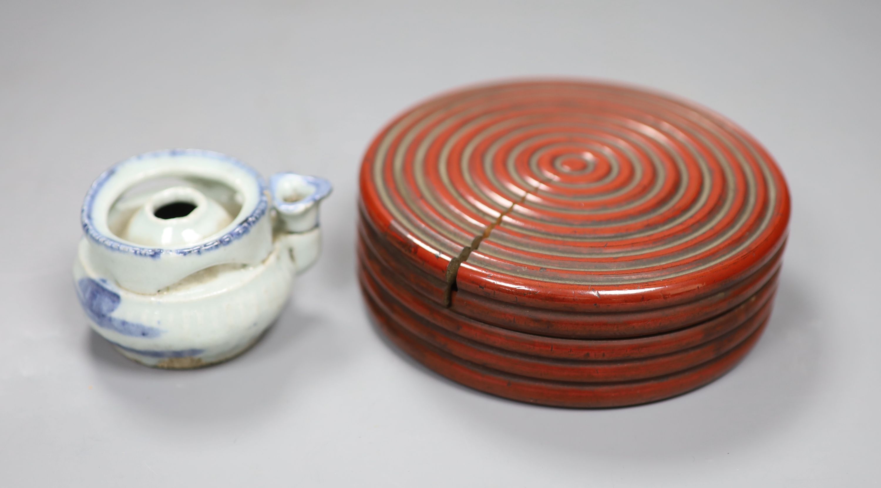 A Chinese red lacquer lidded box, diameter 12.5cm, and a blue and white water dropper